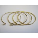 Three rigid 9ct gold Bangles and a Bangle set two brilliant-cut diamonds, approx 30gms