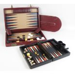 A burgundy leather Backgammon Board with dice, counters, dice cups and doubling cube by Asprey