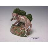 A Staffordshire figure of Tiger with green bocage background on a rustic oval base, restored, 4in H