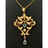 An Edwardian Aquamarine and Seed Pearl Pendant/Brooch, the openwork plaque millegrain-set round