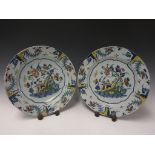 A pair of 18th Century Delft polychrome Plates painted rustic cottage and flowers, 13in, A/F