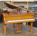 A Morley of London satinwood cased symmetrical Baby Grand Piano on square tapering supports,