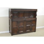 A 17th Century oak Court Cupboard with carved frieze above pair of solid panelled doors having