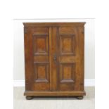 An antique walnut Continental Cabinet fitted seven short and two long drawers enclosed by a pair