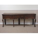 An 18th Century oak Dresser Base fitted three short drawers above shaped frieze on four cabriole