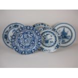 An 18th Century Delft blue and white Charger painted cherub surrounded by flowers, 13 1/2 in and