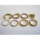 Three 9ct gold twisted Wedding Bands, a 9ct gold Seal Signet Ring, and 9ct gold tri-coloured Ring