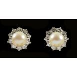 A pair of Cultured Pearl and Diamond Earrings each set cultured pearl within frame of ten