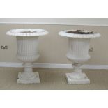 A large pair of cast iron Garden Urns of fluted and gadroon design on circular bases, 2ft 8in D x