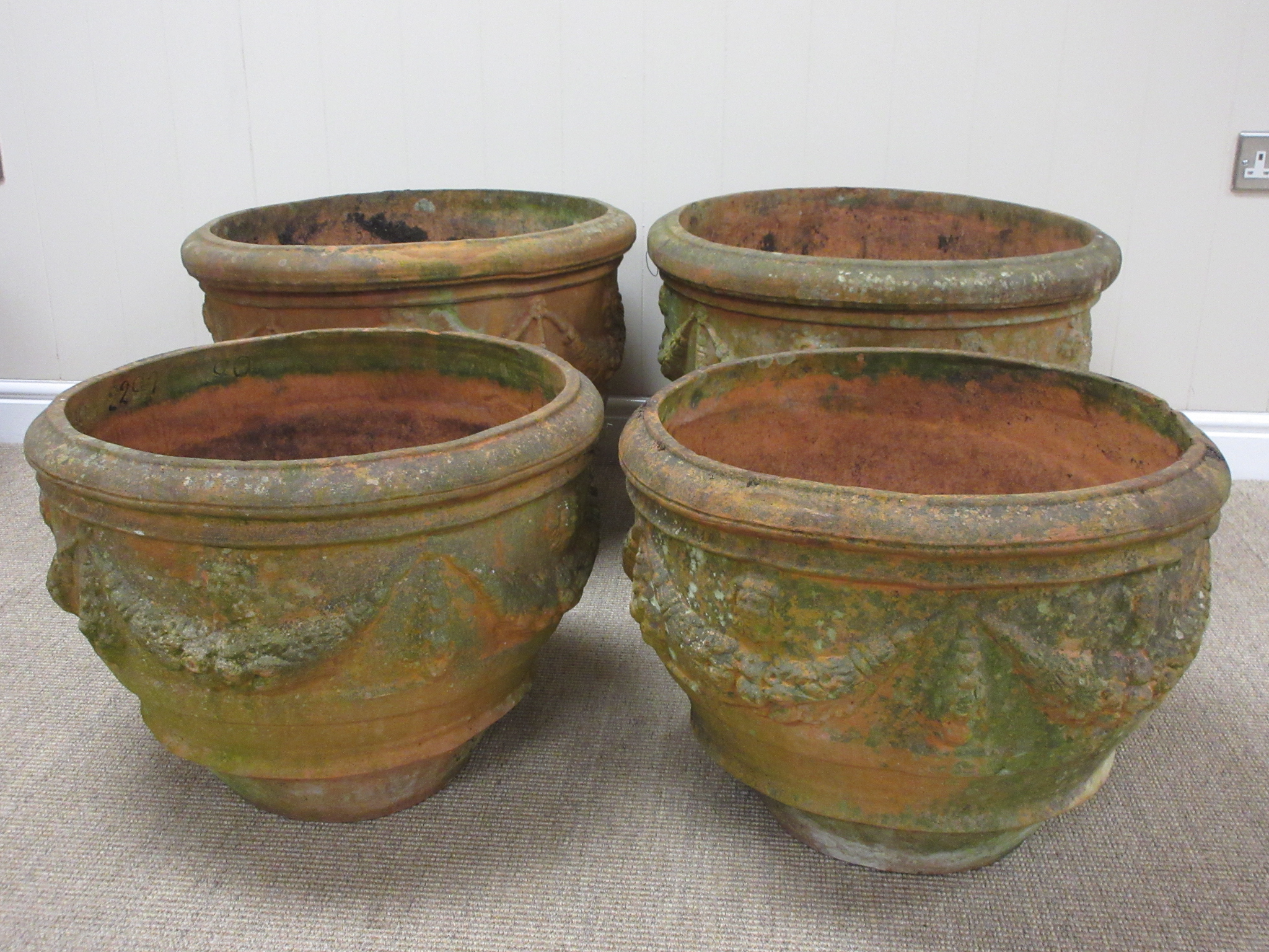 Four terracotta Flower Pots with swag and mask designs, A/F