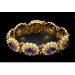 An Amethyst and Seed Pearl Bracelet having nine oval links each claw-set oval-cut amethyst within