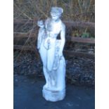 An Italian white marble effect Classical Maiden with flowing robes on circular base and octagonal