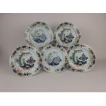 Five Delft polychrome Plates with floral and stylised border, central landscape design with mountain