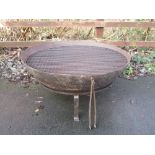 A large iron Kadai with ring handles upon stand with double grill 32in D