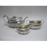 A George III silver three piece Tea Service of boat shape with anthemion and paw feet, London