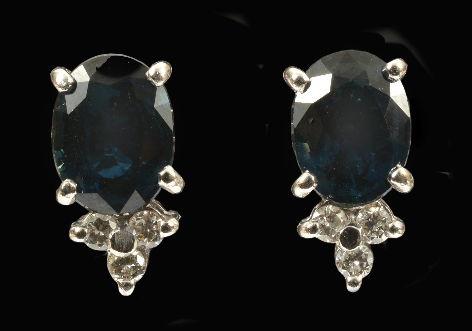 A pair of Sapphire and Diamond Earrings each claw-set oval-cut sapphire, estimated total sapphire