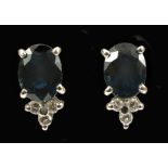 A pair of Sapphire and Diamond Earrings each claw-set oval-cut sapphire, estimated total sapphire