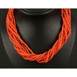 A vintage Coral rope Necklace having ten strands of beads with gold bead spacers on gold barrel