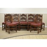 A set of one dozen 17th Century style Derbyshire oak Dining Chairs wirh scroll carved arched