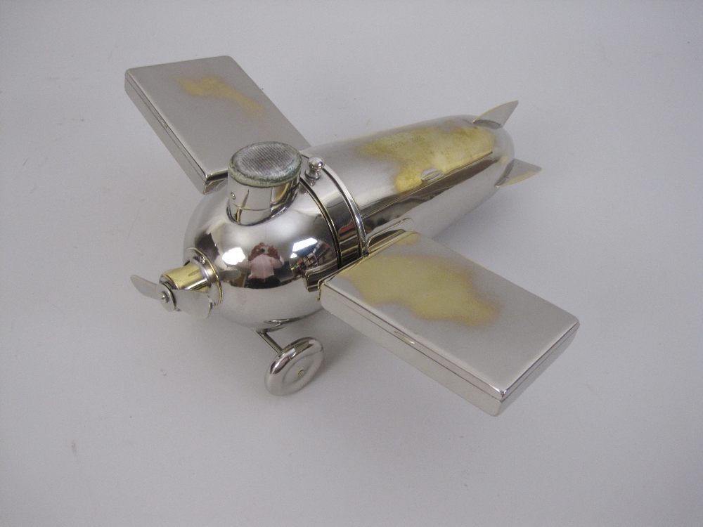 An unusual electroplated Novelty Aeroplane Smoker's Set, with match compartment and striker,