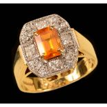 A Yellow Sapphire and Diamond Cluster Ring corner claw-set step-cut sapphire within a frame of