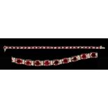 A Ruby and Diamond Bracelet claw-set twenty six oval-cut rubies, total ruby weight 11.30cts,