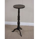 An 18th Century oak Candle Stand with dished circular top on vase turned and simulated bamboo column