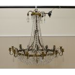 A large circular twelve branch Chandelier with friezes of baguette cut glass, and pear shape pendant
