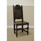 A 17th Century oak Side Chair with floral and leafage scroll carved arched top above floral carved