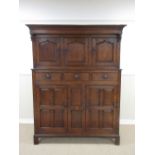 An 18th Century oak Court Cupboard, the upper section with three cupid's bow panelled doors