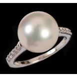 A Cultured Pearl and Diamond Ring set large cultured pearl between pavé-set brilliant-cut diamonds