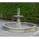 An antique carved stone Fountain, the central column of four large dolphins (probably 17th