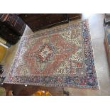 An antique Heriz Carpet, multi-bordered with central star and floral motifs on a cream ground,