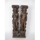 A pair of 17th Century carved oak Pilasters of bearded figures holding trident and mallet, scallop