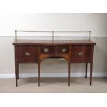 A 19th Century mahogany serpentine fronted Sideboard with brass rail to the back, fitted central