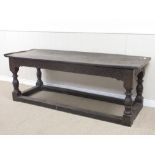 A 17th Century joined oak Refectory Table with two plank cleated top on baluster turned supports and