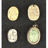 A collection of four Egyptian Scarabs, comprising an 18th Dynasty cream steatite scarab with