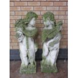 A pair of Garden Cherubs, one with grapes, one with drapes, on square bases, 3ft 6in