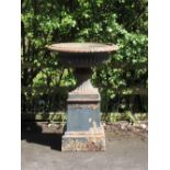 A large 19th Century green painted Garden Urn with egg and dart rim to the gadroon bowl, on square