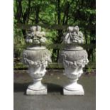 A pair of Garden Finials of vase and cover form with swag design and floral surmounts on square