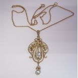 An Edwardian Aquamarine and Seed Pearl Pendant millegrain-set round aquamarine in openwork plaque