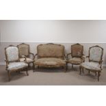 A French gilt five piece upholstered Salon Suite with scroll carved crests, scrolled and carved arms