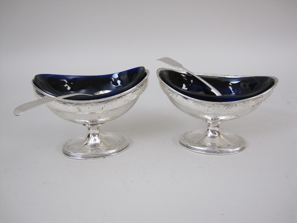 A pair of George III silver oval pedestal Salts with floral engraved frieze and initial W, London