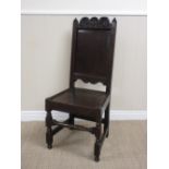 A 17th Century oak Side Chair with scallop carved top rail, plain fielded panel back, solid seat