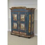 A large 19th Century Continental painted pine Armoire with pair of doors decorated panels of