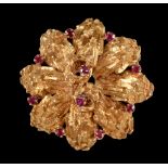 An 18ct gold Flowerhead Brooch, the textured mount claw-set round rubies, approx 13gms