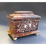 A 19th Century tortoiseshell Tea Caddy of sarcophagus shape with floral inlay, two interior lidded