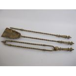 A set of three antique brass Fire Implements with embossed shovel, floral engraving and spiral