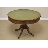 A 19th Century oak Drum Table, the leather inset circular top above two drawers and six false