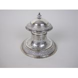 An Edward VII silver circular Capstan Inkstand with floral and strapwork embossing, hinged lid,